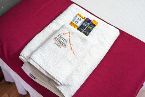 a pile of towels sitting on top of a bed at Cabañas Tierra Mistica in Ushuaia