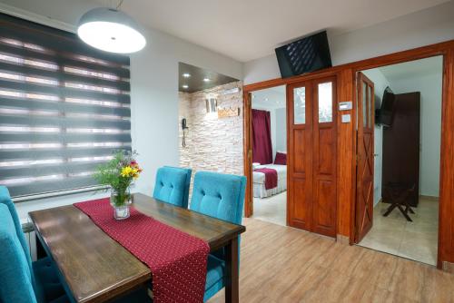 a dining room with a table and blue chairs at Cabañas Tierra Mistica in Ushuaia