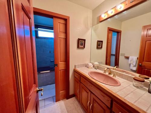 a bathroom with a sink and a mirror at Sierra Lake View at Rubicon by Tahoe Getaways - 3 BR, Panoramic Lake Views, Private Hot Tub & Private beach! in Tahoma