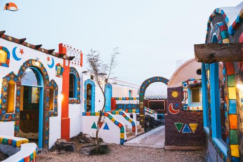 a group of buildings with paintings on them at Nuba Narty in Aswan