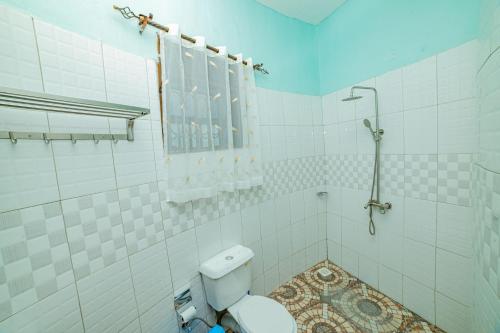 a bathroom with a toilet and a shower at Entuiga cottages in Hoima