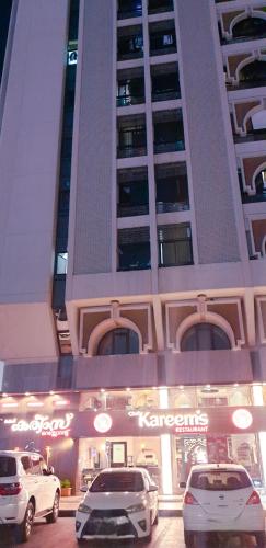 two cars parked in front of a building at MAMA DELiGHT HOME in Abu Dhabi