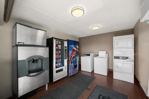 a kitchen with refrigerators and appliances in a room at Red Roof Inn Dallas - DFW Airport North in Irving