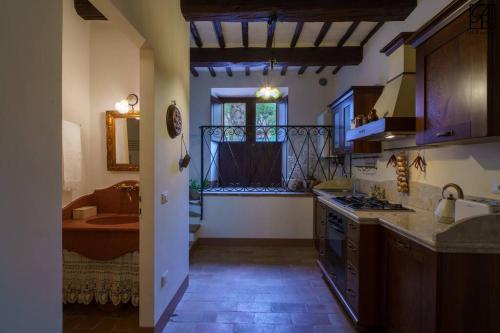 a kitchen with a sink and a window in a room at Il Rustico di Palazzo Rossi in Sarnano