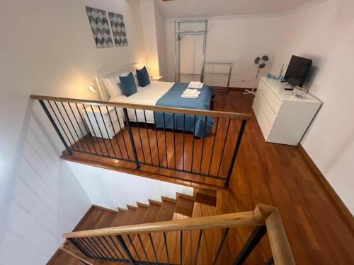 a small room with a bed and a staircase at Atlantic Dream Alto Mar in Garajau