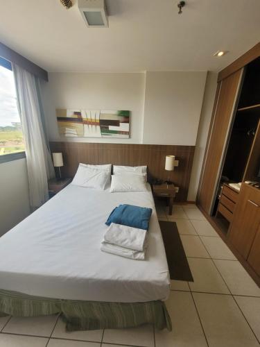 a bedroom with a large white bed and a window at Flat Nobile Suítes Monumental By Rei dos Flats, in Brasilia