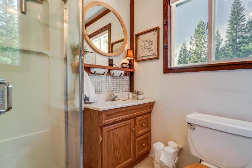 a bathroom with a toilet and a sink and a mirror at Charming Soda Springs Cabin Hike, Ski and Golf! in Soda Springs