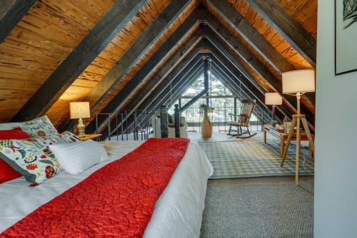 a bedroom with a red bed in a attic at Charming Soda Springs Cabin Hike, Ski and Golf! in Soda Springs