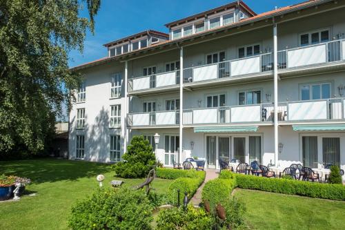 a large white building with a garden in front of it at Hotel St. Martin in Marktoberdorf