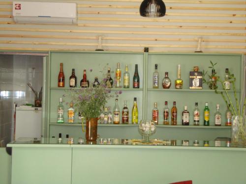 a room with shelves filled with bottles of alcohol at Marianna Hotel in Alexandroupoli