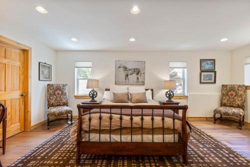 a bedroom with a bed and two chairs at Trailside - Alpine Meadows 6 Bedroom with Private Hot tub in Alpine Meadows