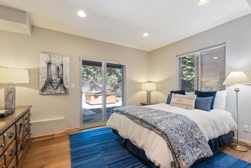 a bedroom with a bed and a window at Trailside - Alpine Meadows 6 Bedroom with Private Hot tub in Alpine Meadows