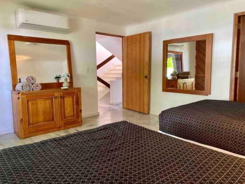 a bedroom with a bed and a large mirror at *Villa Sicilia Lagoon front by Casa Paraiso* in Cancún