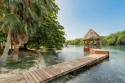a wooden dock with a gazebo on a river at *Villa Sicilia Lagoon front by Casa Paraiso* in Cancún
