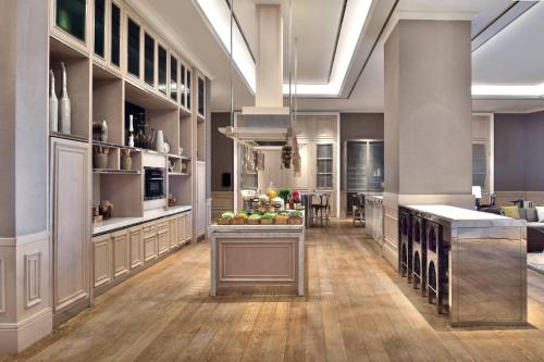 a large kitchen with a counter with fruits on it at JW Marriott Hotel Kolkata in Kolkata