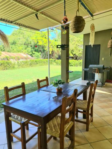 a dining room table and chairs with a view of a yard at casita de lola in Ciudad Valles