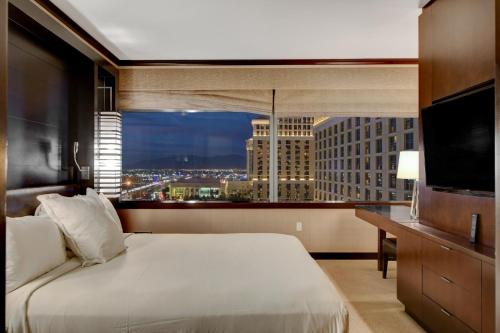 a hotel room with a bed and a large window at Vdara Hotel & Spa in Las Vegas