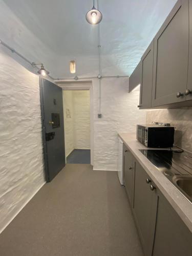a kitchen with a sink and a counter top at Victorian Police Station Apartment in Launceston