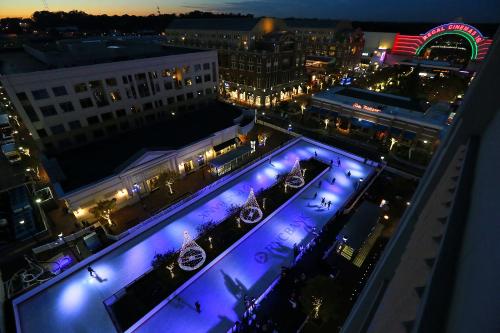 a view of a city at night with blue lights at Grand 3br loft in Atlantic Station in Atlanta