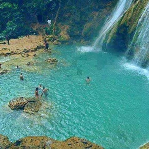 a group of people swimming in the water near a waterfall at Riad Casa Youssef in Chefchaouene