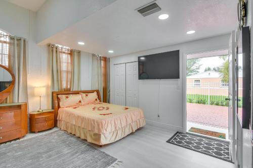 a bedroom with a bed and a flat screen tv at Miami Gardens Studio with Patio 12 Mi to Ocean! in Miami Gardens