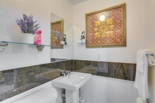 a bathroom with a sink and a tub and a mirror at Miami Gardens Studio with Patio 12 Mi to Ocean! in Miami Gardens