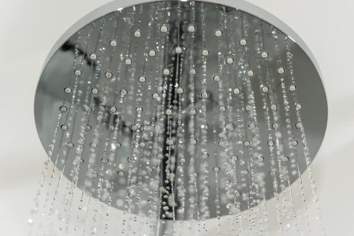 a shower head with water droplets on it at Dorfmeister Business Hotel B&B in Weikersdorf am Steinfelde