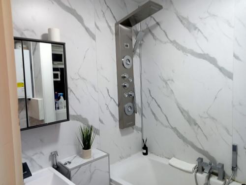 a white bathroom with a sink and a mirror at Studio apartment in London, Bethnal Green in London