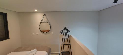 a room with a mirror and a tripod next to a staircase at Villa Licuri Boiçucanga in Boicucanga