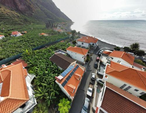 an aerial view of a village next to the ocean at Maresia's House in Madalena do Mar