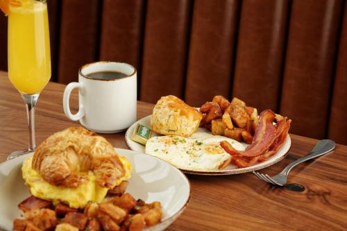 a table with two plates of breakfast food and a cup of coffee at Eurostars Magnificent Mile in Chicago