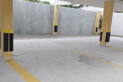 an empty parking lot with yellow and black columns at Villa Licuri Boiçucanga in Boicucanga