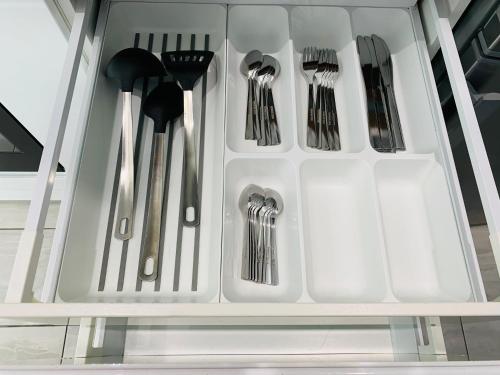 a white drawer with utensils in it at Beautiful, Luxurious 3 Bed house, Perfect for Contractors , Family & Friends in Dartford