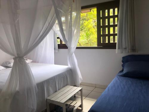 A bed or beds in a room at Vila Enayá