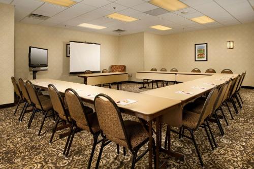 a conference room with tables and chairs and a whiteboard at Drury Inn & Suites Frankenmuth in Frankenmuth