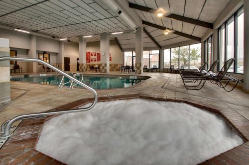 a pool with a hot tub in the middle of a building at Drury Inn & Suites Albuquerque North in Albuquerque