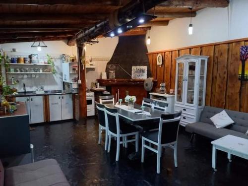 a kitchen and dining room with a table and chairs at LO DE ROCCO in Esquel