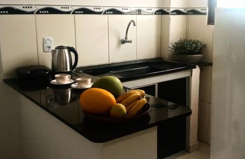 a kitchen counter with a bowl of fruit on it at Mangue em flor in Maxaranguape