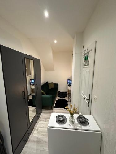 a small living room with a couch and a table at Superbe appartement hyper centre-ville de Melun in Melun