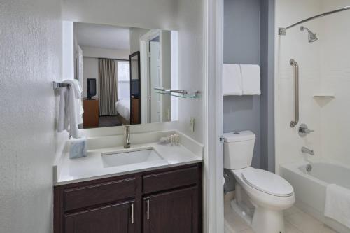 a bathroom with a sink and a toilet and a tub at Residence Inn Shreveport Airport in Shreveport