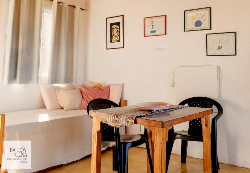 a living room with a table and a couch at Cabañas Balcon de Luna in El Carmen