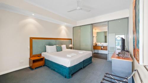 a bedroom with a bed and a television in it at Sea Side 112 in Mandurah