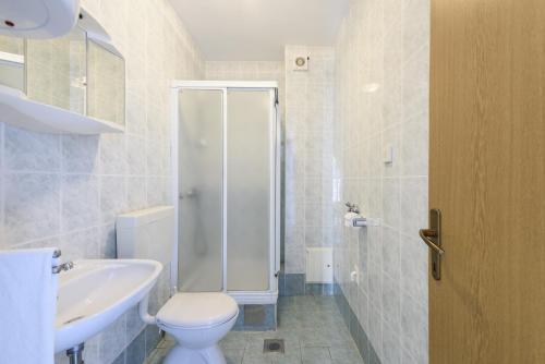 a bathroom with a shower and a toilet and a sink at Apartment Sveti Petar 6158c in Sveti Petar