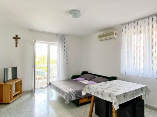 a bedroom with a bed and a cross on the wall at Apartment Sveti Petar 6158c in Sveti Petar
