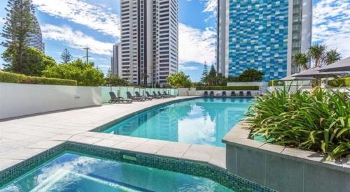 a swimming pool in a city with tall buildings at 3BR Apartment Hinterland Views - Sierra Grand CoastHM in Gold Coast