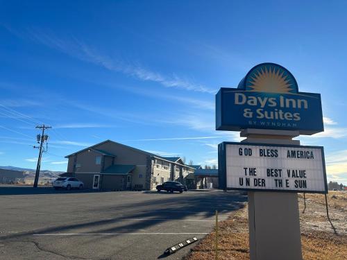 a sign for days inn and suites on a street at Days Inn & Suites by Wyndham Gunnison in Gunnison