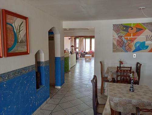 a dining room with a table and chairs and a room at Pousada Kanaxuê in Barra Velha