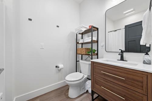 a bathroom with a sink and a toilet and a mirror at Riverview in Port Clinton - Apt. B 