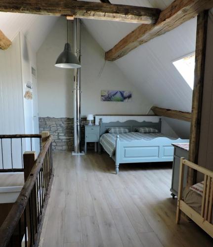 a bedroom with a bed in a attic at Vakantieboerderij Ferme Le Bleuet in Ohey