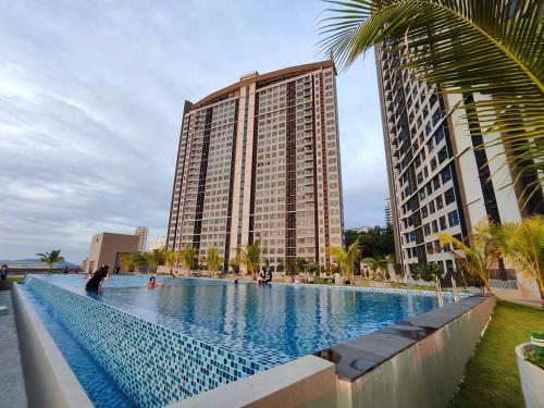 a large swimming pool in front of a tall building at Jesselton Quay Rashzia Kota kinabalu in Kota Kinabalu